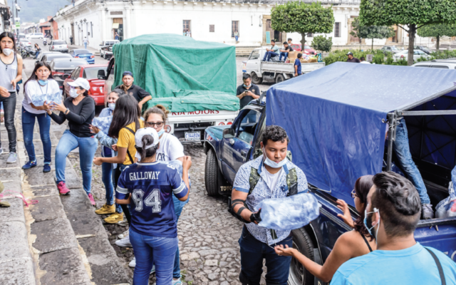 Line of workers handing out disaster supplies