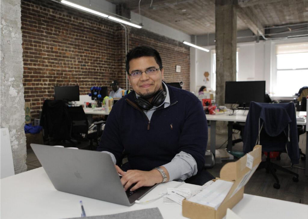 Man with computer in workspace