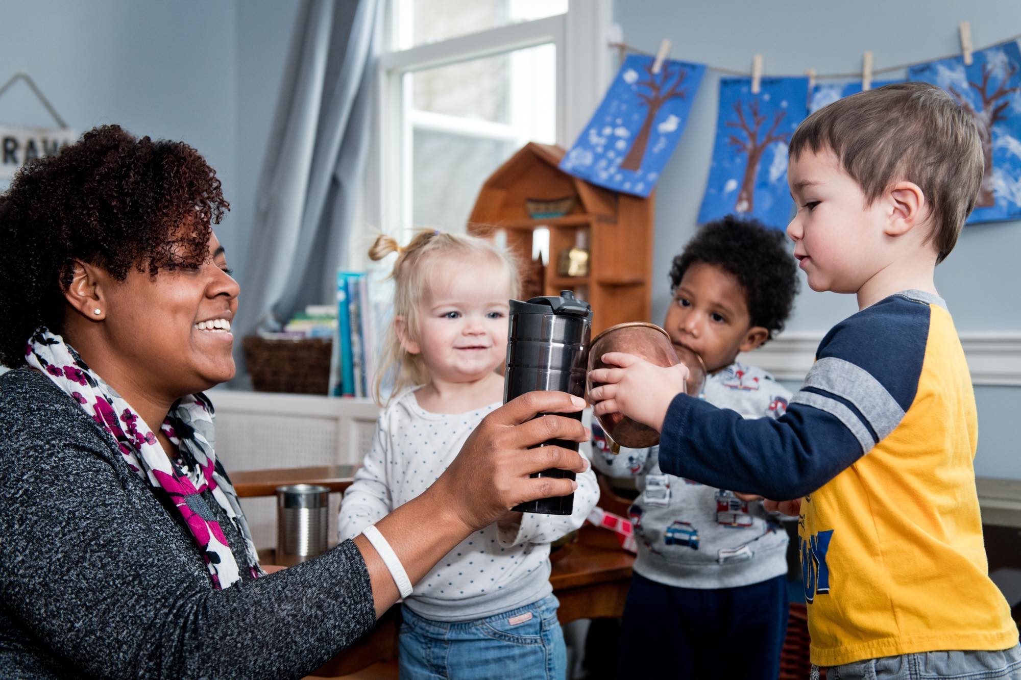 Woman surrounded by children in a daycare setting