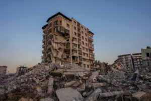 Damaged building surrounded by rubble following the February 2023 earthquakes in Turkey.