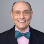 Richard Marker with smile, glasses, and bow tie