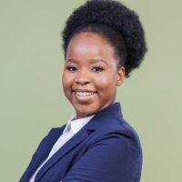 Smiling young woman in blue blazer with a headband in her hair