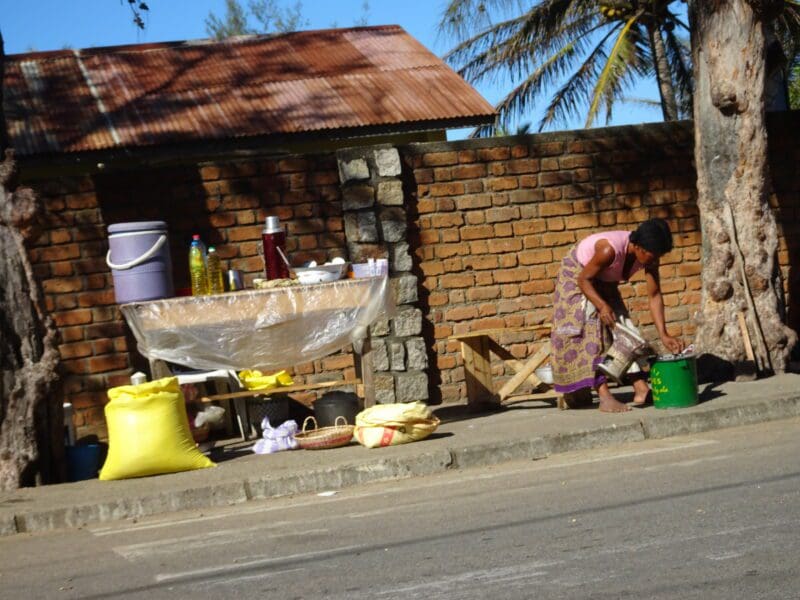 A woman in Madagascar cooking using her cookstove.